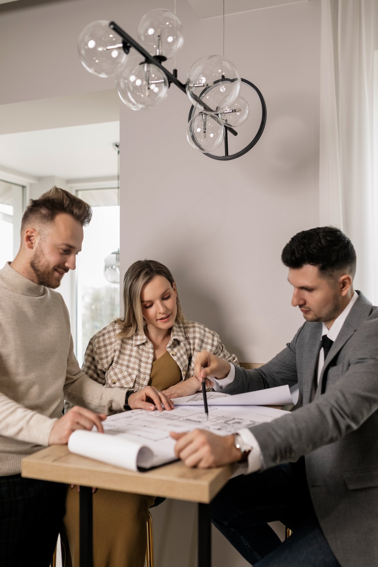 Real Estate Agent Showing a Blueprint to a Couple